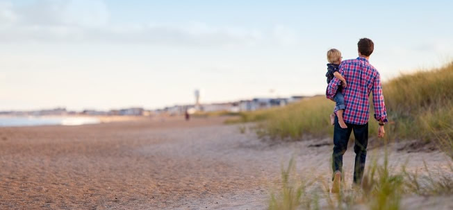 Man and child on the beach